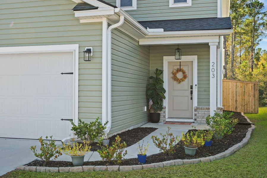 Exterior details and patio area of a home in Jasmine Point at Lakes of Cane Bay, Summerville (Image 3).