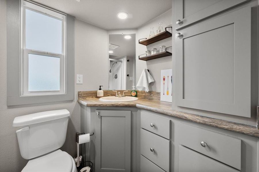 The full bath includes all the necessities with more cabinetry to keep everything stashed away.
