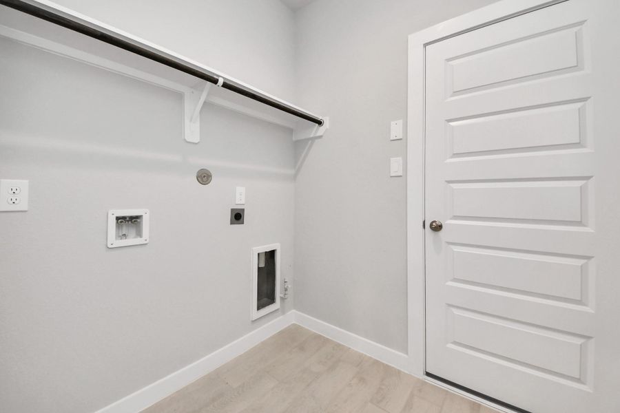 A perfect blend of functionality and comfort. Capture the essence of easy living with a first-floor laundry room, thoughtfully equipped with shelving for effortless organization. Both electric and gas connections available.