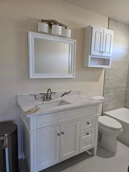 Bathroom featuring vanity and washtub / shower combination Bathroom featuring vanity and washtub / shower combination