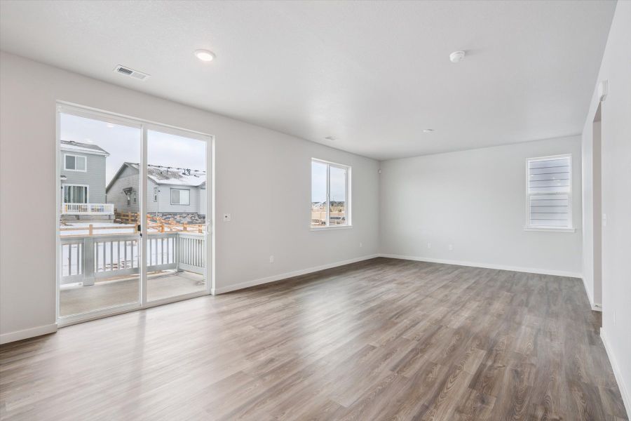 A room with a wood floor and a glass door. A room with a wood floor and a glass door.