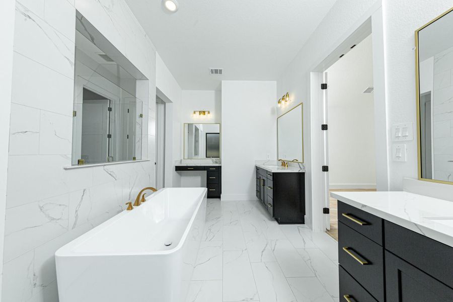 Additional view of dual vanities which also includes another vanity with knee space, allowing for a comfortable, seated grooming experience.