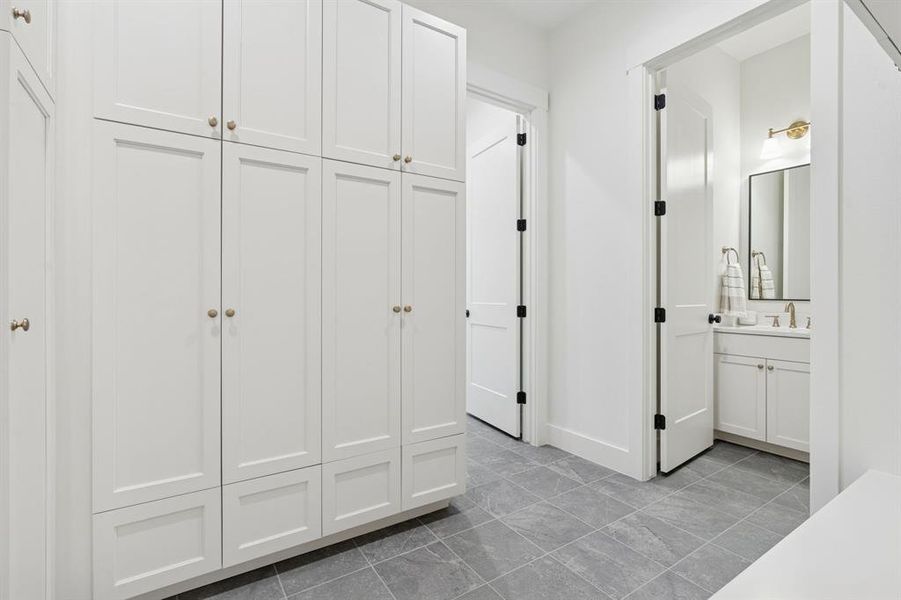 Mud area with incredible storage options; closet lockers and open cubbies.
