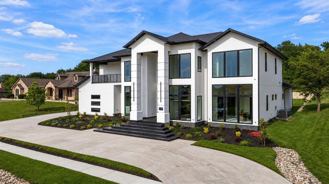 Contemporary architecture featuring a white exterior and black-framed windows