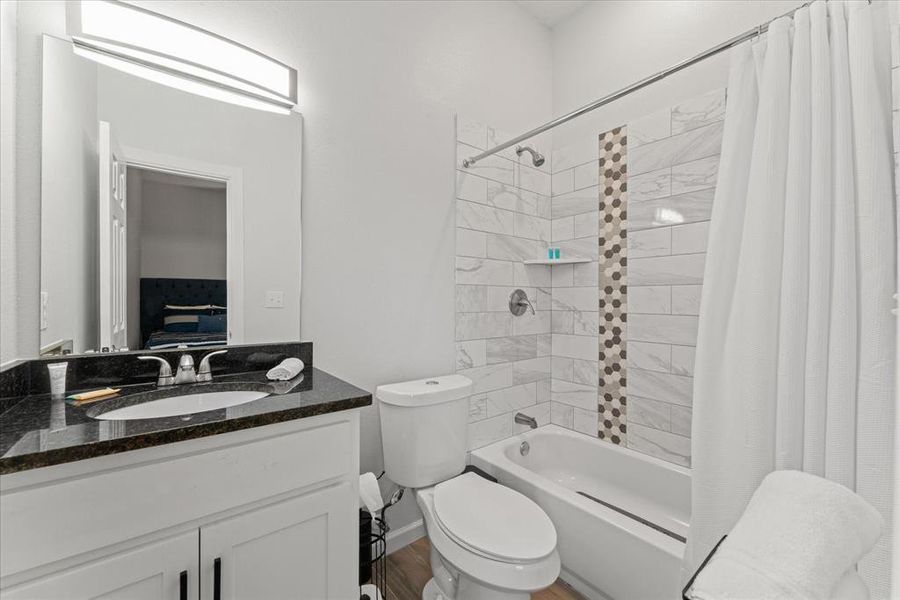 Bathroom featuring shower / bath combo and vanity