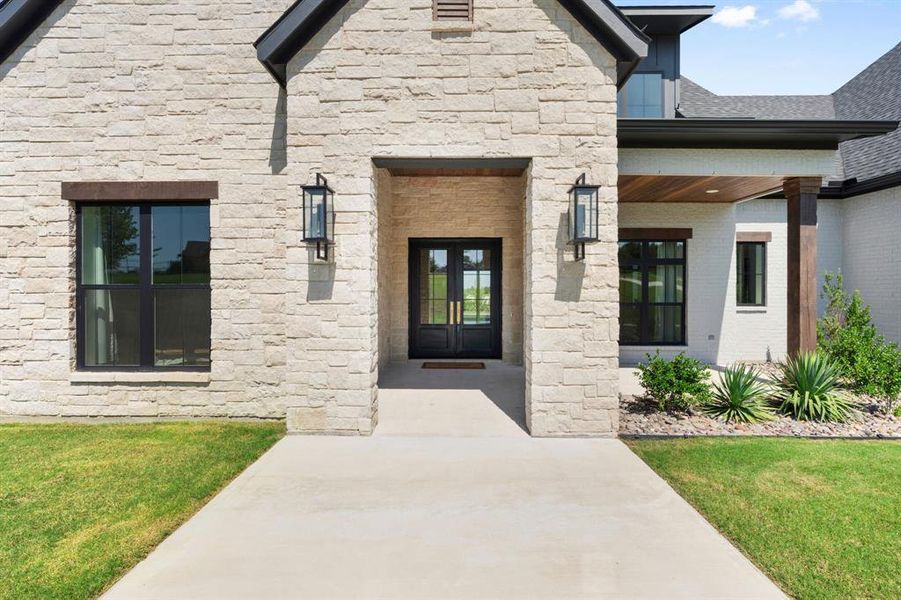 Doorway to property with a yard