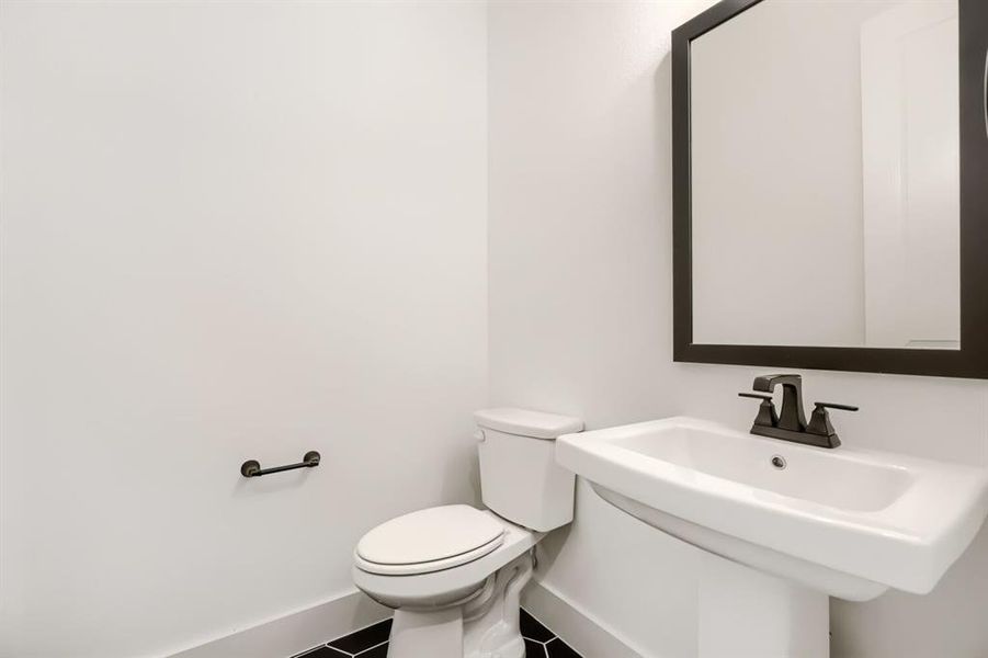 Bathroom with baseboards and tile patterned flooring