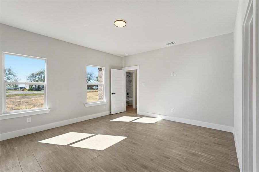 Spare room with baseboards and wood finished floors