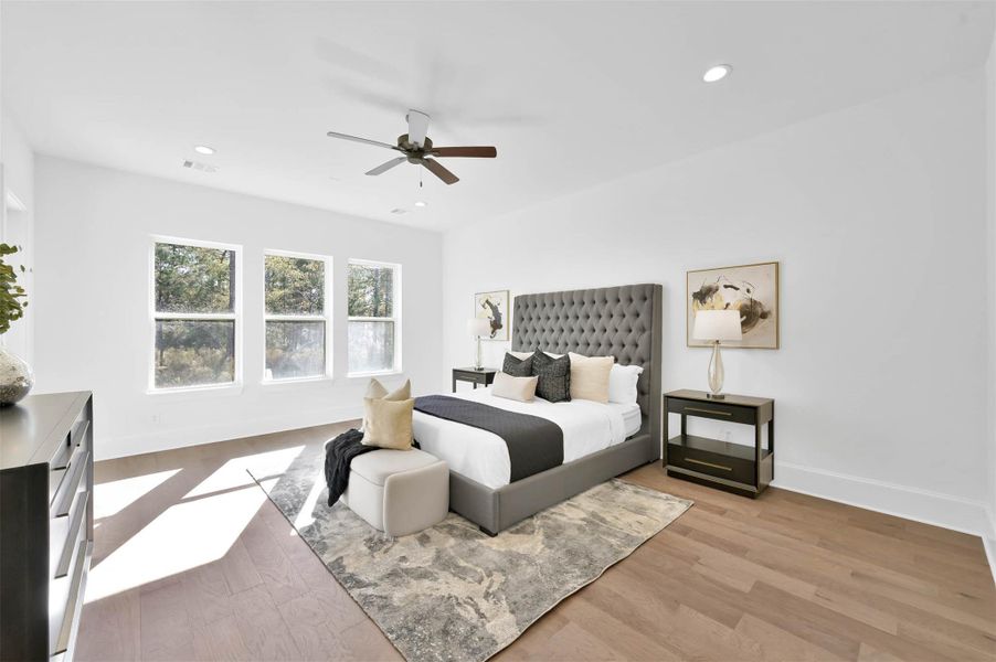 Elegant primary suite is spacious with high ceilings and custom wood floors. Elegant primary suite is spacious with high ceilings and custom wood floors.