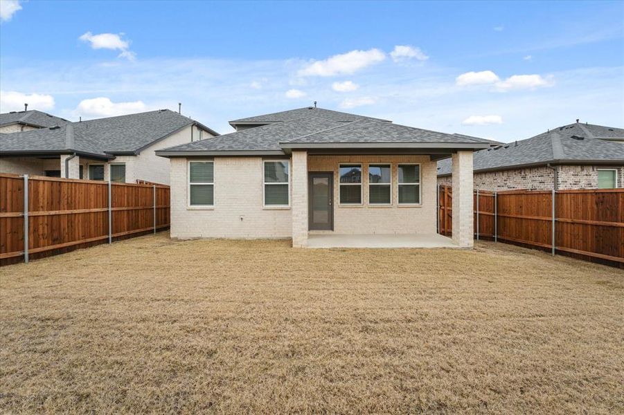 Rear view of property featuring a patio area and a yard