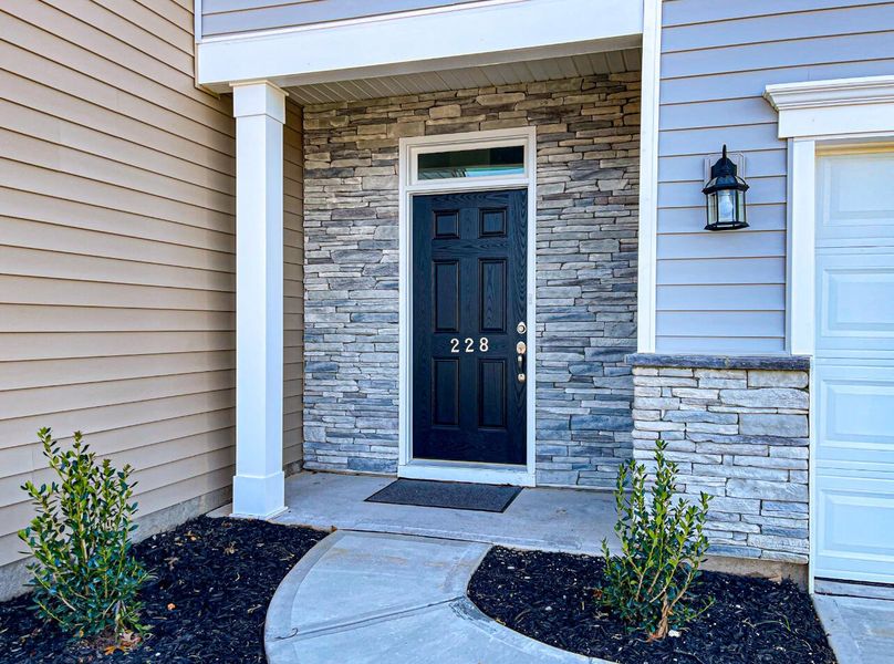 Front exterior of a new home in Bellevue Townhomes, Greenville, SC, highlighting curb appeal (Image 2).
