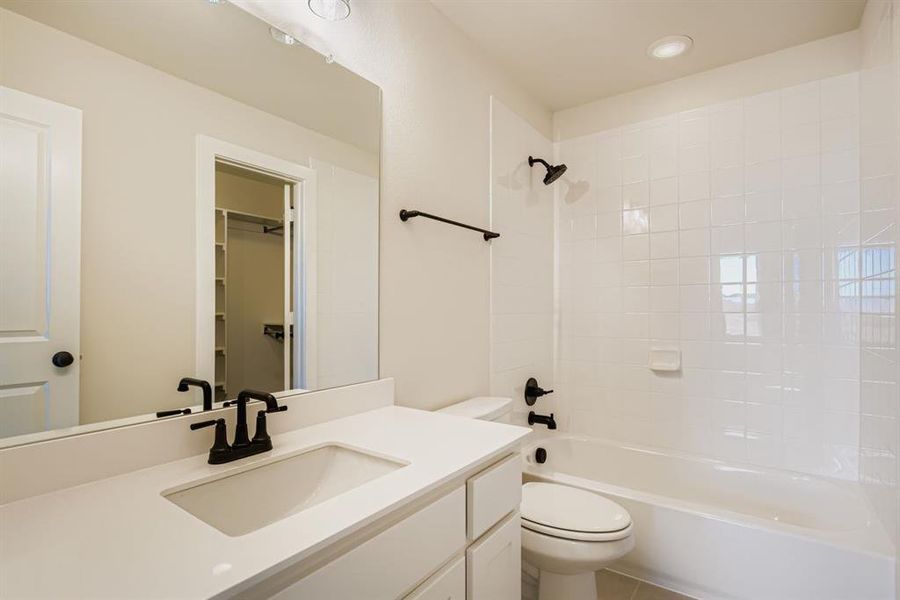 Bathroom featuring bathtub / shower combination, vanity, recessed lighting, a spacious closet, and tile patterned flooring