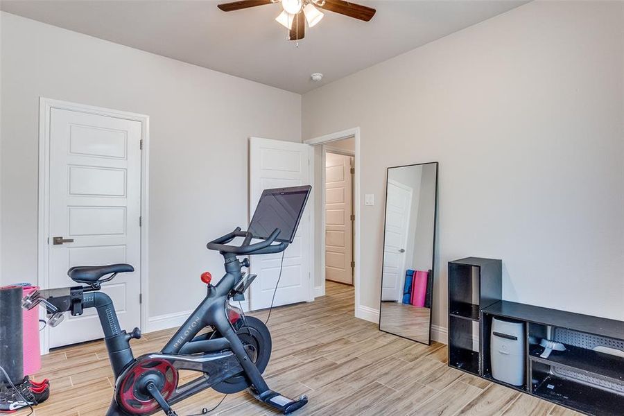 Workout room featuring wood finish floors and ceiling fan