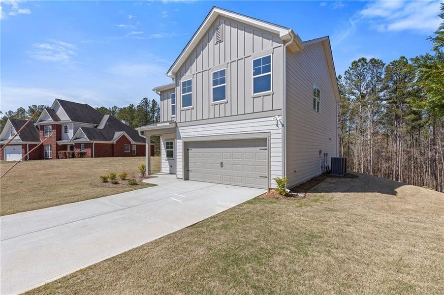 Front exterior of a new home in High Shoals, Dallas, GA, highlighting curb appeal (Image 1).