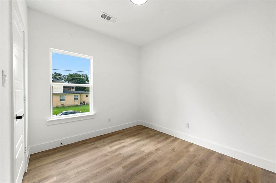 Unfurnished room featuring hardwood / wood-style flooring