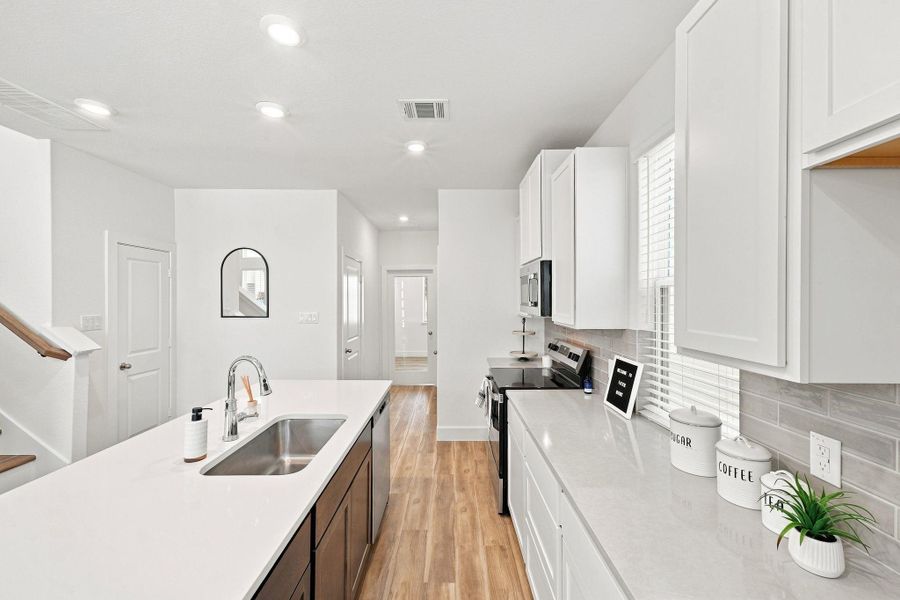 Bright, functional kitchen showcasing generous counter and cabinet space, a large center island, stainless-steel appliances, and contemporary finishes throughout. Bright, functional kitchen showcasing generous counter and cabinet space, a large center island, stainless-steel appliances, and contemporary finishes throughout.