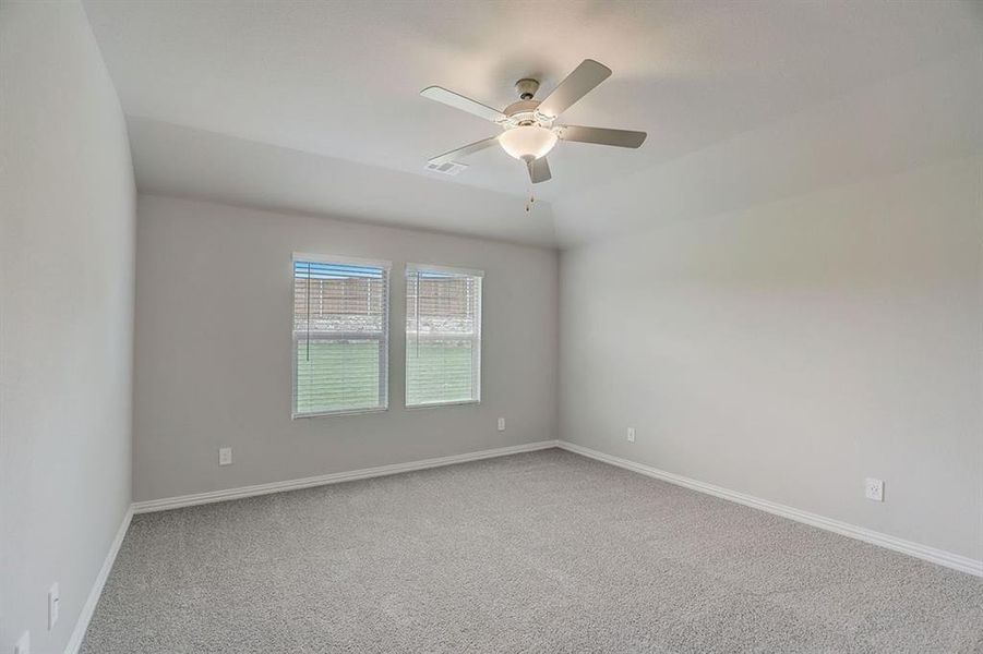 Spare room with ceiling fan and carpet floors