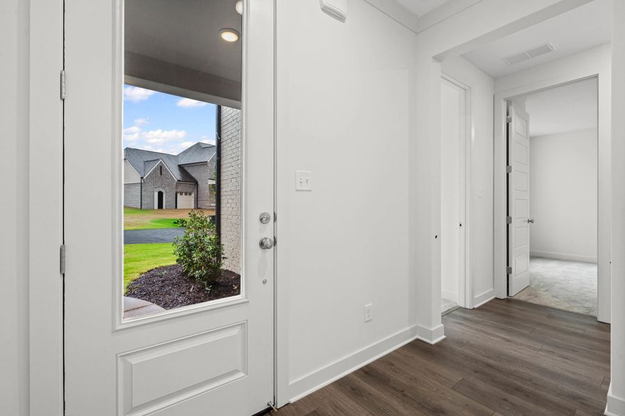 Foyer entrance featuring baseboards and dark wood-style flooring