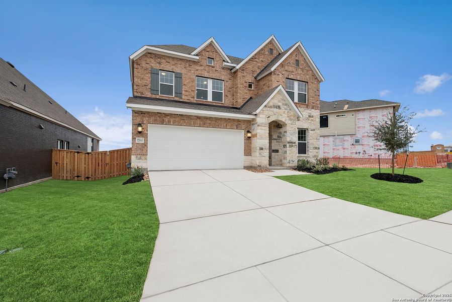 Front exterior of a new home in Windsong - Reserve Series, Boerne, TX, highlighting curb appeal (Image 1). Front exterior of a new home in Windsong - Reserve Series, Boerne, TX, highlighting curb appeal (Image 1).