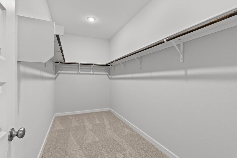 A white hallway with a metal railing. A white hallway with a metal railing.