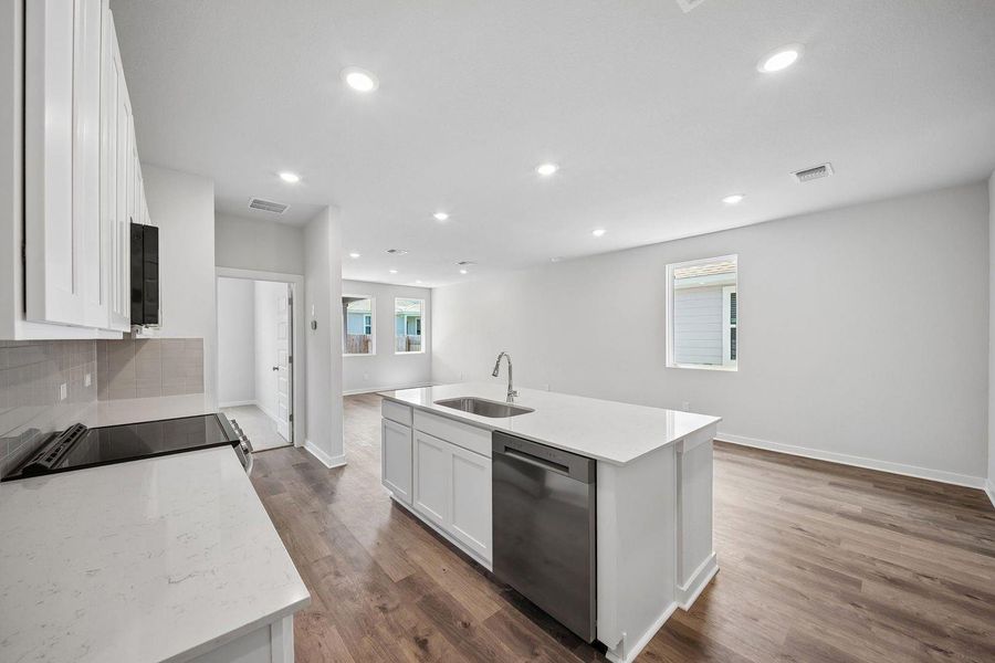 Culinary creations come to life in this modern kitchen, featuring a central island and rich hardwood floors. Culinary creations come to life in this modern kitchen, featuring a central island and rich hardwood floors.