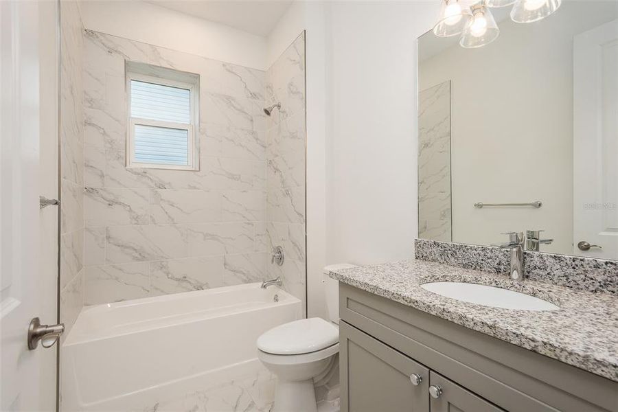 Laundry, Elevator Door Guest Bathroom of Sold Model Home