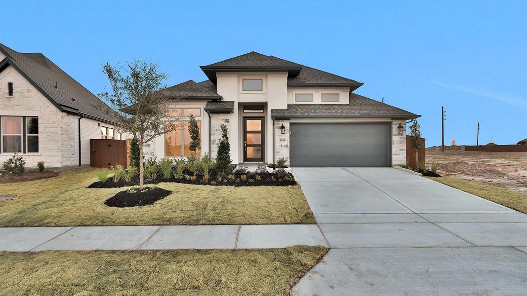 Front exterior of a new home in Meridiana, Manvel, TX, highlighting curb appeal (Image 2).
