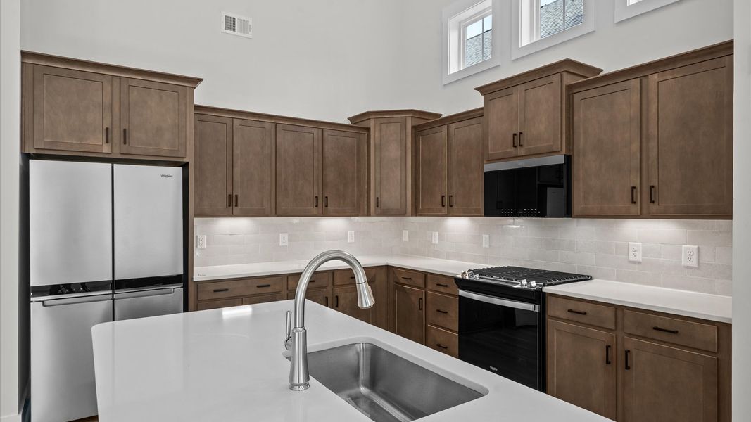 Exclusive DRB Homes kitchen with an 8-foot island and elevated finishes in a prime location Exclusive DRB Homes kitchen with an 8-foot island and elevated finishes in a prime location