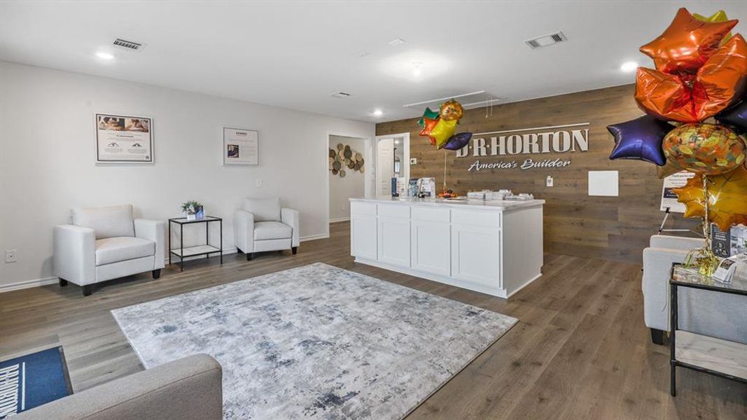 Spacious interior featuring wood-finish flooring, recessed lighting, and a prominent wood-paneled accent wall