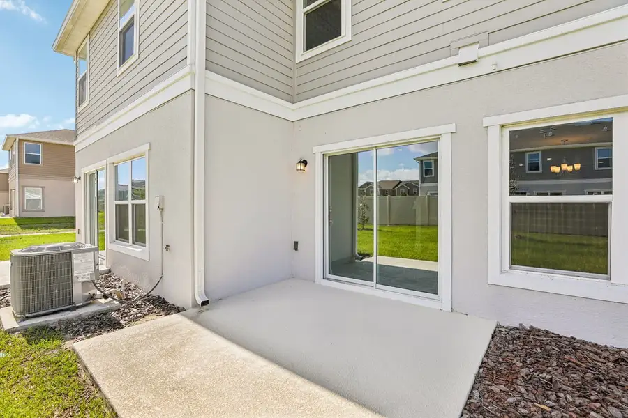 Exterior details and patio area of a home in Reserve at Forest Lake Townhomes, Lake Wales (Image 3).
