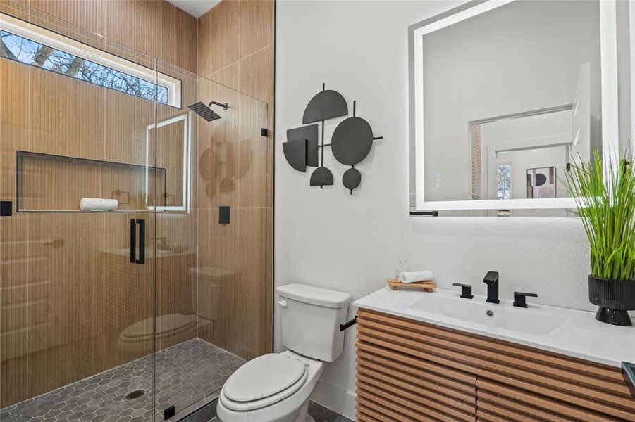 Bathroom with a shower stall and vanity