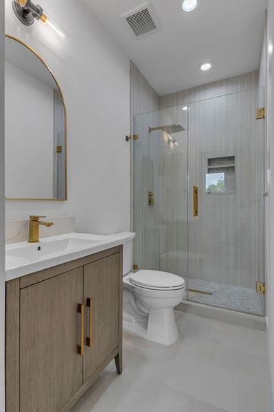 Full bathroom with vanity, a shower stall, recessed lighting, and tile patterned floors Full bathroom with vanity, a shower stall, recessed lighting, and tile patterned floors