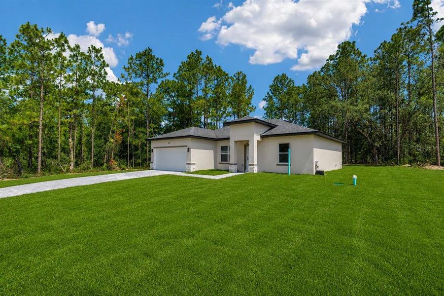 Front exterior of a new home in , Citrus Springs, FL, highlighting curb appeal (Image 1). Front exterior of a new home in , Citrus Springs, FL, highlighting curb appeal (Image 1).