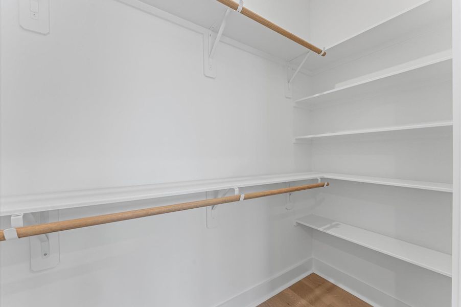 This spacious primary bedroom offers a luxurious retreat, complete with two generously sized closets designed for optimal organization and convenience.
