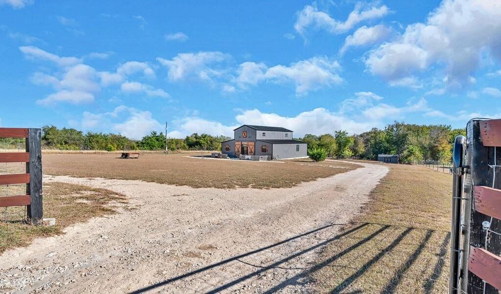 View of dirt / gravel driveway with a gated entry View of dirt / gravel driveway with a gated entry