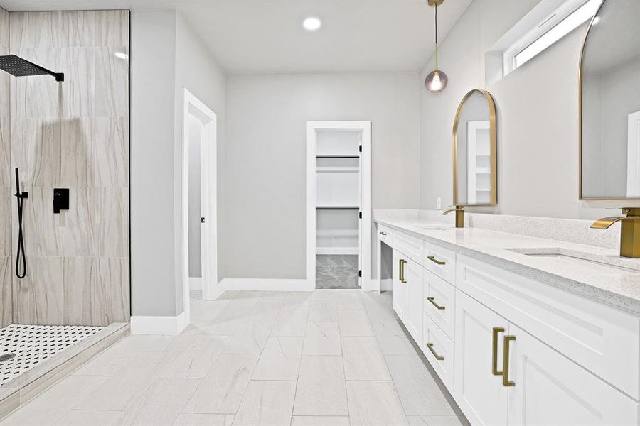 Bathroom with vanity and tiled shower