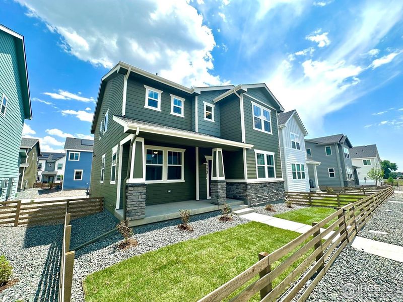 Front exterior of a new home in Waterfield, Fort Collins, CO, highlighting curb appeal (Image 25). Front exterior of a new home in Waterfield, Fort Collins, CO, highlighting curb appeal (Image 25).