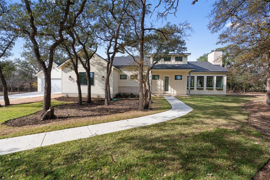 View of front of home with a front lawn, a chimney, and a porch View of front of home with a front lawn, a chimney, and a porch