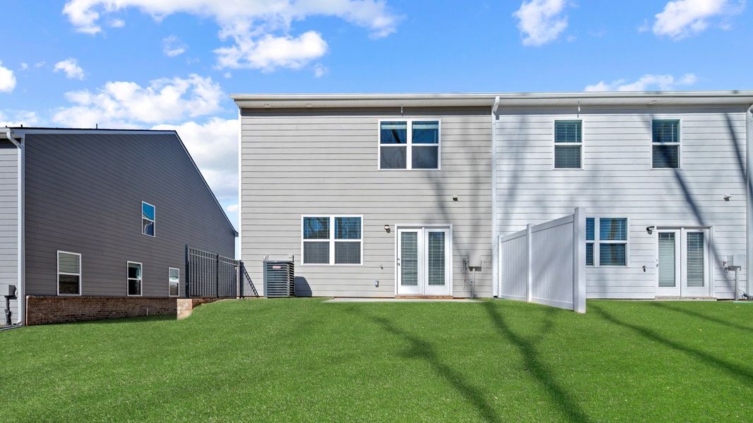 Exterior details and patio area of a home in Inverness at Sugarloaf, Lawrenceville (Image 2).