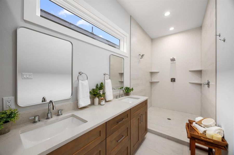 Stunning primary bathroom featuring a spacious walk-in shower, dual vanity with elegant quartz countertops, and modern fixtures for a spa-like retreat. Separate water closet for privacy.