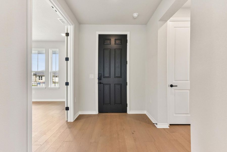 Entrance foyer featuring light wood-style floors and baseboards