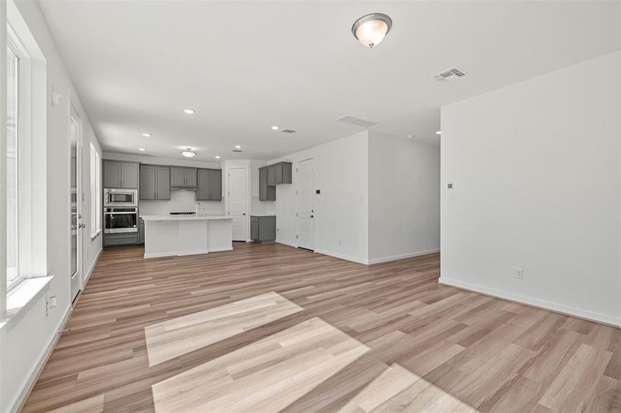 Unfurnished living room featuring recessed lighting and light wood-type flooring Unfurnished living room featuring recessed lighting and light wood-type flooring