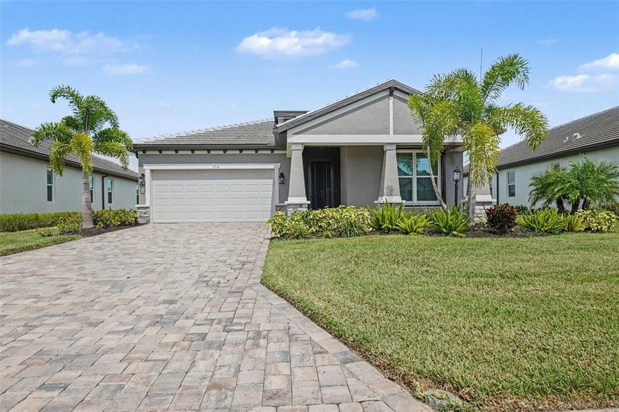 Front exterior of a new home in Cypress Glen at River Wilderness, Parrish, FL, highlighting curb appeal (Image 2). Front exterior of a new home in Cypress Glen at River Wilderness, Parrish, FL, highlighting curb appeal (Image 2).