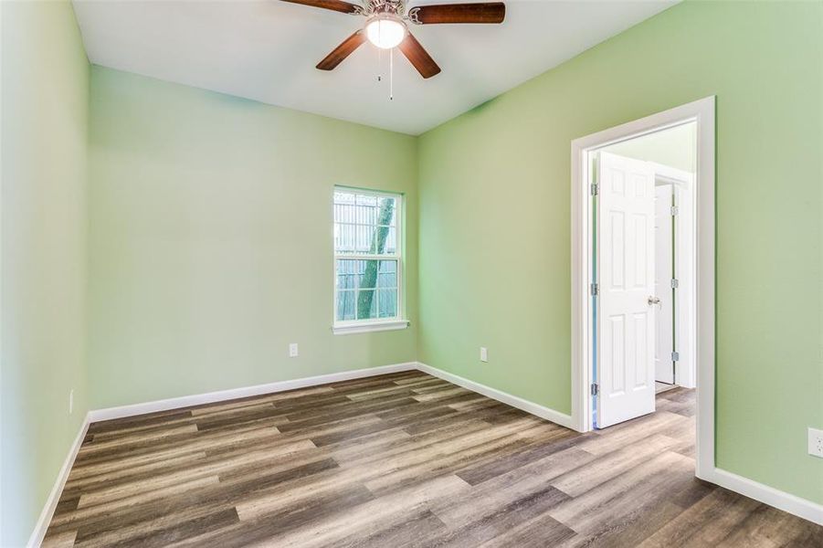 Spare room with hardwood / wood-style floors and ceiling fan