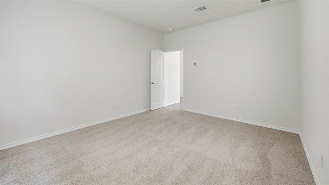 Empty room with light carpet and baseboards Empty room with light carpet and baseboards