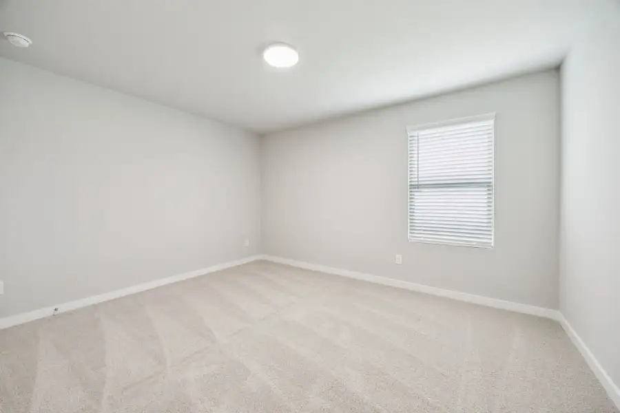 Bedroom in the Hayden home plan by Trophy Signature Homes – REPRESENTATIVE PHOTO