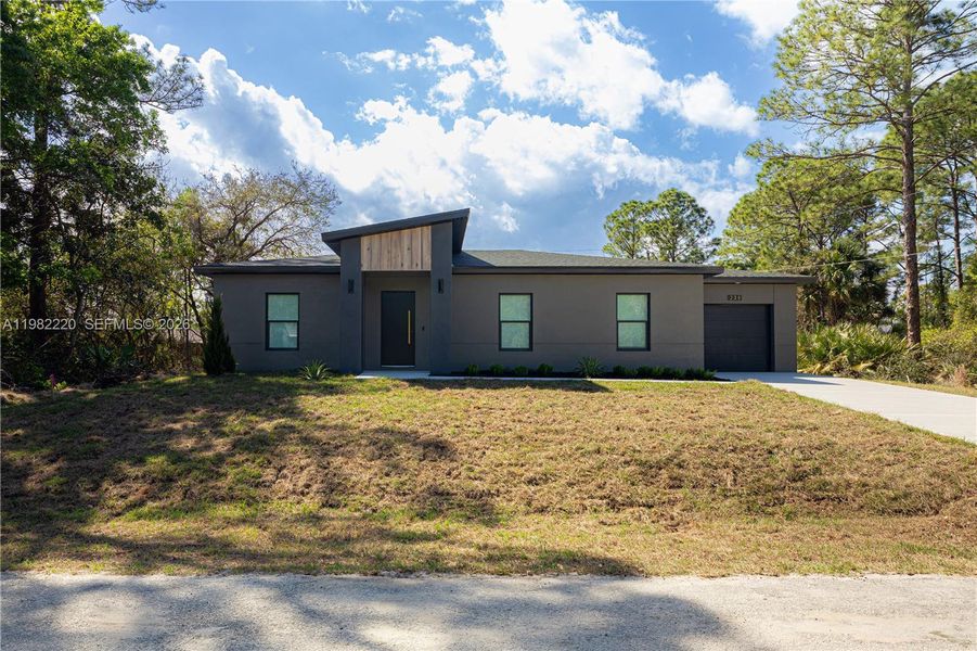 Front exterior of a new home in , Palm Bay, FL, highlighting curb appeal (Image 26).