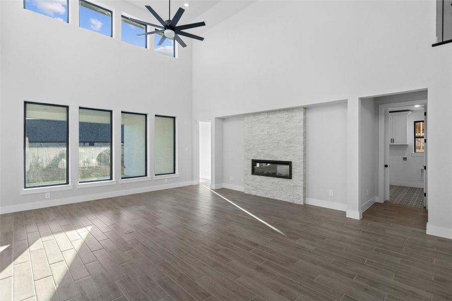 Enjoy the open and airy Family Room, designed for seamless entertaining and showcasing striking architectural details with high ceilings and durable flooring. The centerpiece of this Great Room is the stunning fireplace!