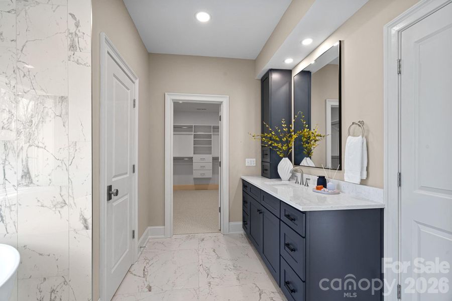 Relax and rejuvenate in this spa-like Primary Bath, complete with dual vanities, a soaking tub, a stunning shower, and elegant tiled floors and walls.
