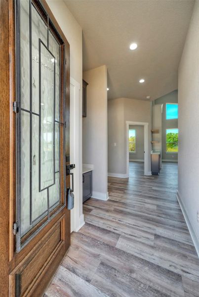 An inviting entryway leads past a modern drop zone into a bright, open floor plan. An inviting entryway leads past a modern drop zone into a bright, open floor plan.